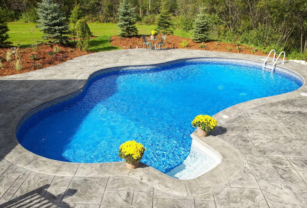Custom shaped pool with clear water and pool coping