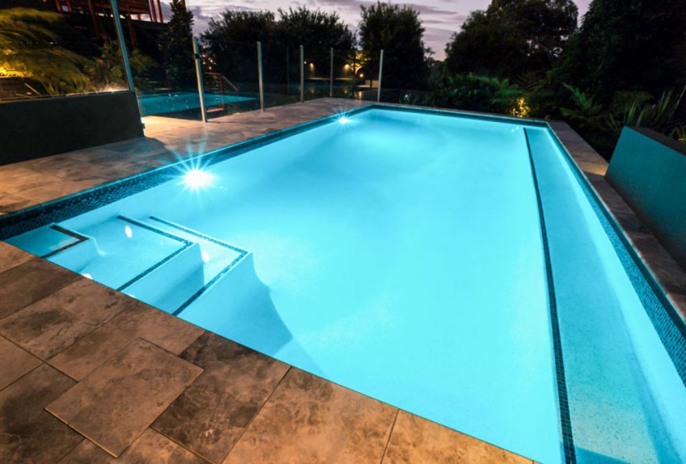 White plaster pool resurfacing with a smooth, clean finish that gives the pool a bright and classic appearance.