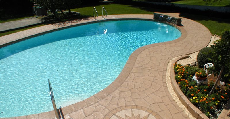 turquoise colored water in a pool with concrete resurfacing