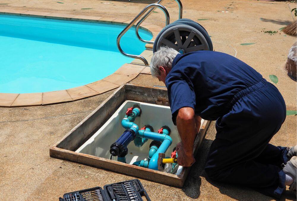 Man in blue shirt fixing pool system