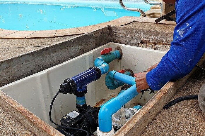 Man working on swimming pool maintenance