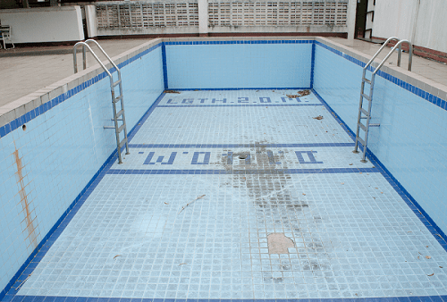 Damaged and cracked surface commercial swimming pool
