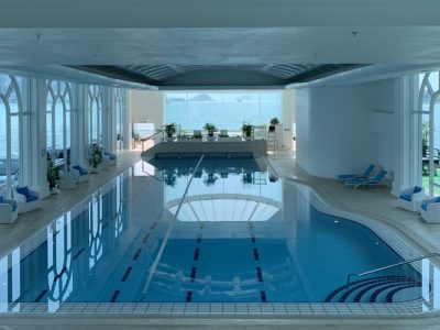 Luxury hotel outdoor pool with modern concrete decking, perfect for relaxation and resort-style lounging in warm weather.