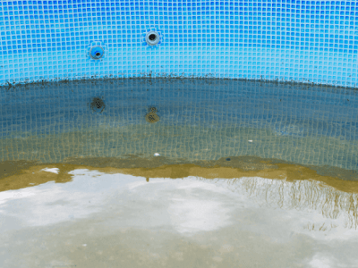 Professional pool repair and restoration for damaged pool surfaces Drained swimming pool with damaged and stained surface in need of professional pool repair