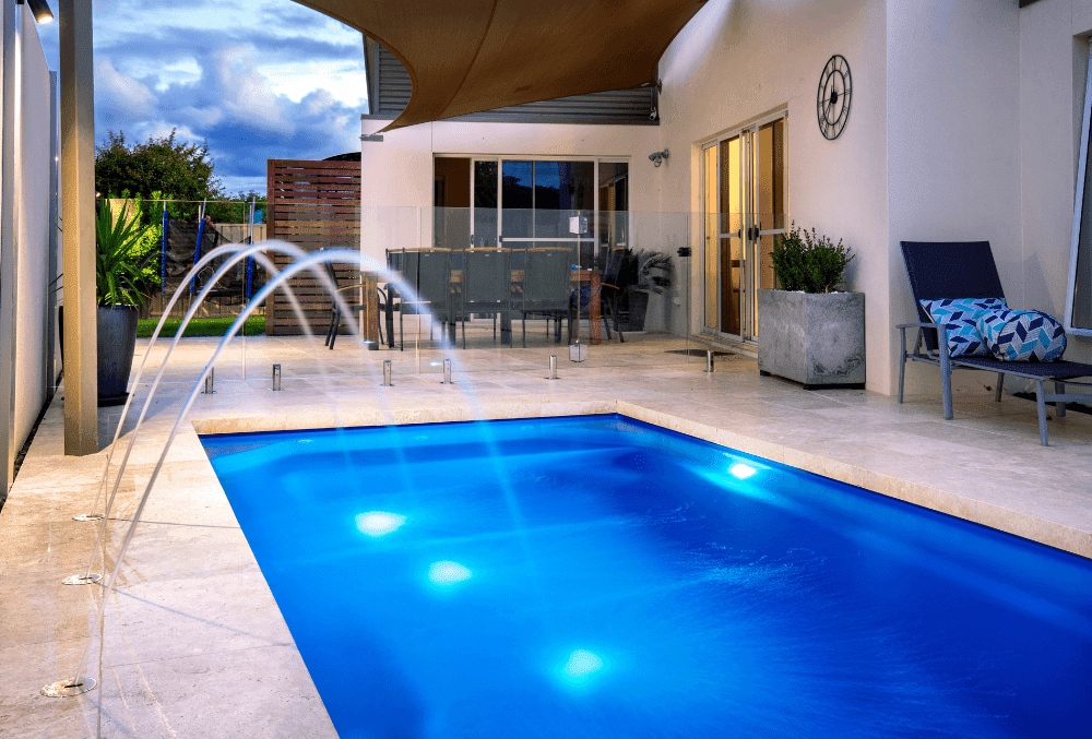 elegant indoor pool with chairs & plants