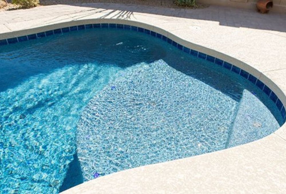 Pebble Tec pool resurfacing featuring a natural pebble texture that enhances durability and gives the pool a luxurious, organic look.
