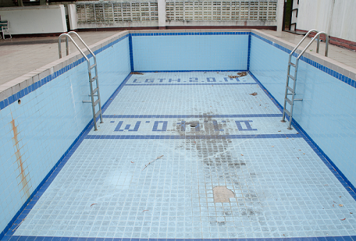 Damaged and cracked surface commercial swimming pool